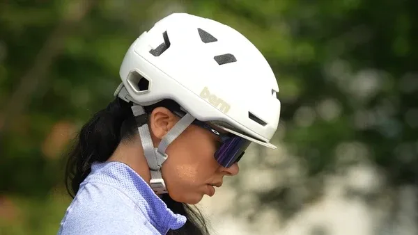 A rider wearing the white Bern Hudson helmet