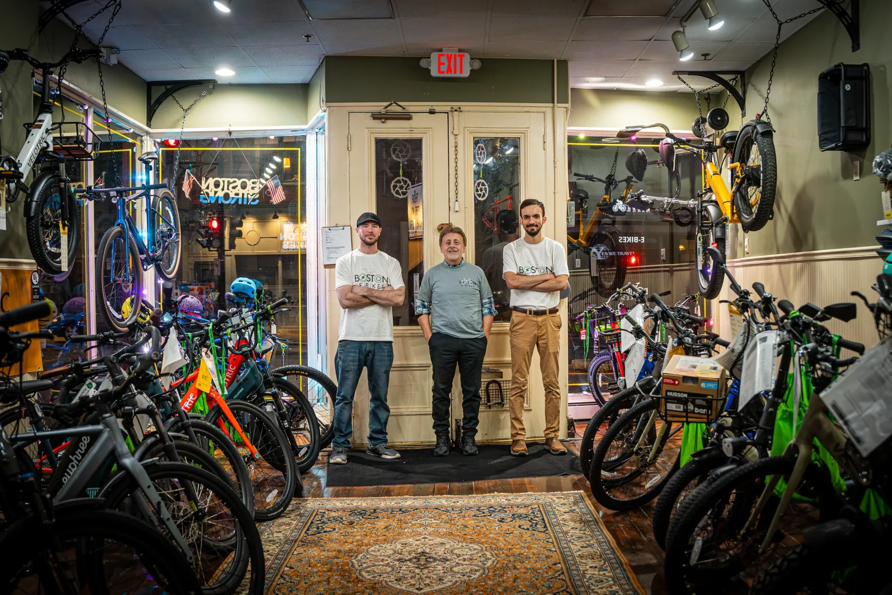 The Boston E-Bikes team inside the shop, surrounded by e-bikes